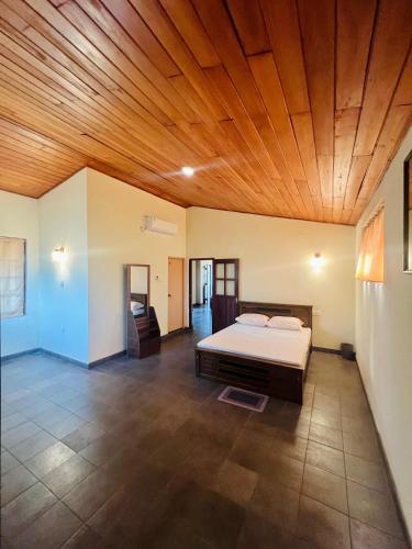 a bedroom with a bed and a wooden ceiling at Lovely Home in Panadura