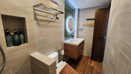 a bathroom with a sink and a mirror at Old City Hall, Contactless Check In in Bangkok