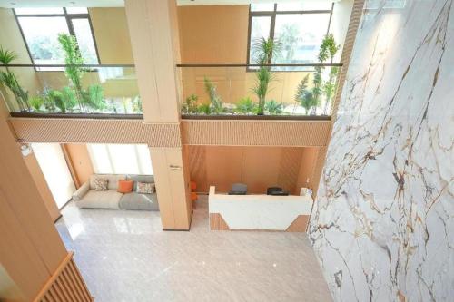a large room with windows and a couch in a building at VELIN Pattaya Hotel-Central Pattaya-2 in Pattaya