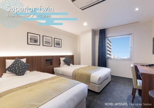 a hotel room with two beds and a desk at HOTEL MYSTAYS Hakodate Station in Hakodate