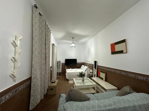 a room with two beds and a living room at Serenity Beach Pinar in Chipiona