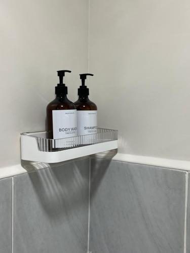 a shelf with two bottles of soap on a wall at AAvista in Basbas