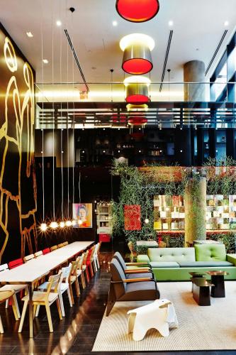 a store with couches and tables in a lobby at citizenM New York Times Square in New York