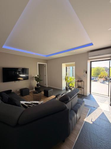 a living room with couches and a blue ceiling at Living Viana do Castelo in Viana do Castelo