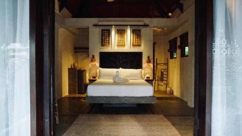 a bedroom with a bed in a room at Cala Tuason Villas in General Luna