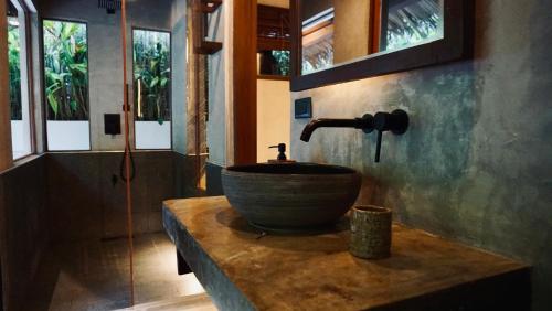 a bathroom with a bowl sink on a counter at Cala Tuason Villas in General Luna