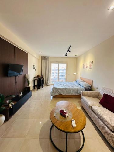 a living room with a bed and a coffee table at Unique Studio Free access beach in Hurghada