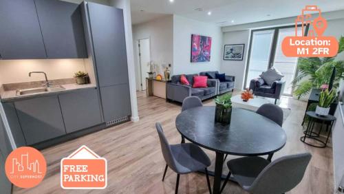 a kitchen and a living room with a table and chairs at Luxury City Centre Townhouse with Parking in Manchester
