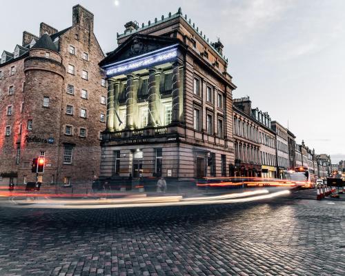 a building on the corner of a city street at The Inn on the Mile in Edinburgh