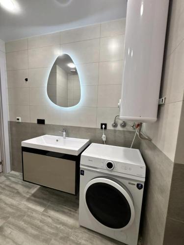a bathroom with a washing machine and a sink at Solis apart otel in Batumi