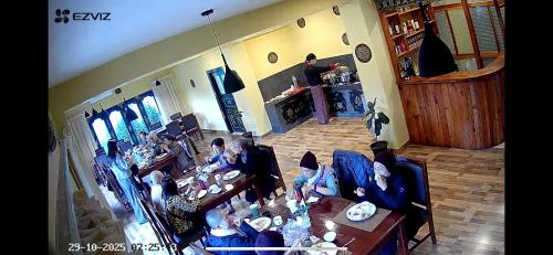 a group of people sitting at a table in a living room at Taktshang Paradise in Paro