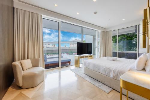 a bedroom with a bed and a large window at Vacationer Holiday Homes I Luxurious 3 Bedroom I Iconic FIVE Palm in Dubai