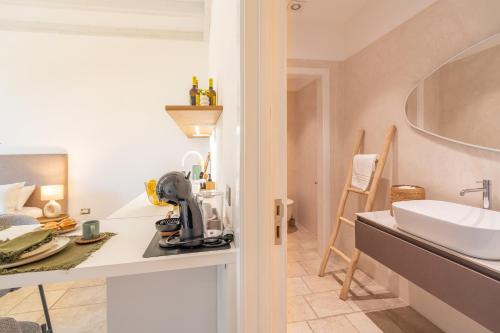 a bathroom with a sink and a counter with a mixer at Mediterranea Residence in Nardò