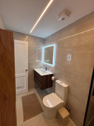 a bathroom with a toilet and a sink at Vista Mar in Mogán