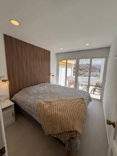 a bedroom with a bed and a balcony at Vista Mar in Mogán