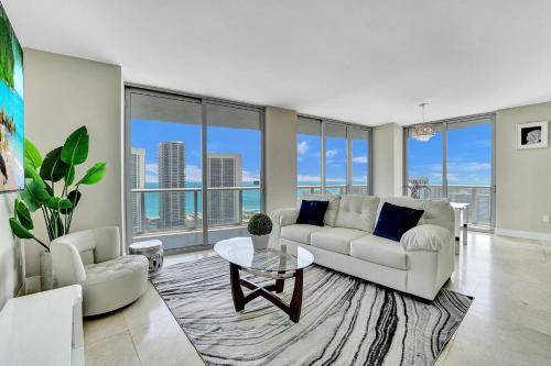 a living room with a couch and a table at Beachwalk Resort in Hallandale Beach