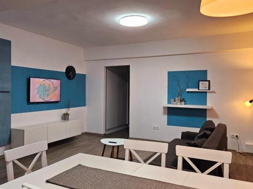 a living room with a couch and a table at Hey! Central Apartment in Gheorgheni