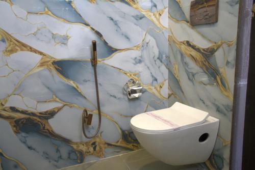 a bathroom with a sink and a toilet at Hotel Sunrise N Resorts in Nagpur
