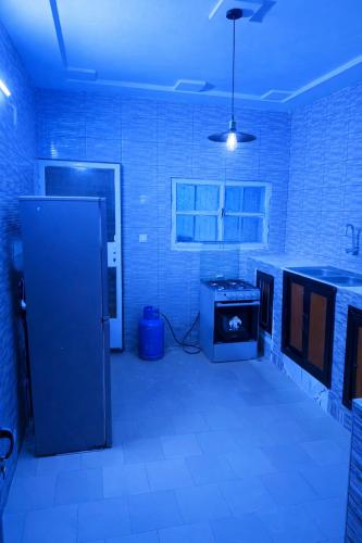 a kitchen with a refrigerator and a stove at Villa Sahel in Niamey