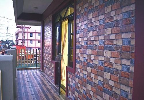 a brick wall with a door on a building at Mebaker View Inn in Shillong