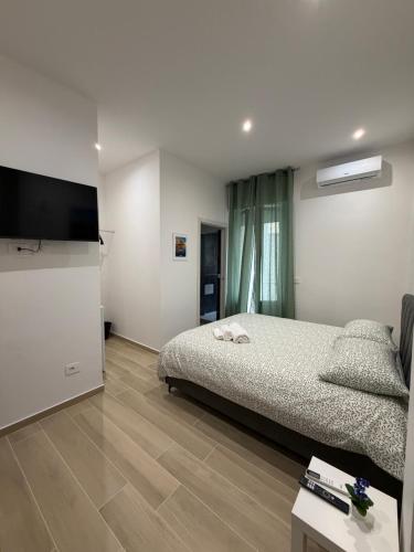 a bedroom with a bed and a flat screen tv at Heart Of Bari in Bari