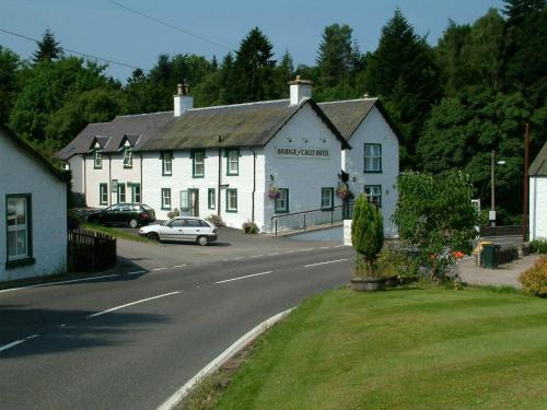 a white building on the side of a road at Bridge of Cally Hotel in Blairgowrie