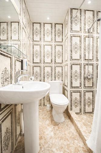 a bathroom with a white sink and a toilet at Old Yerevan by IGIT in Yerevan