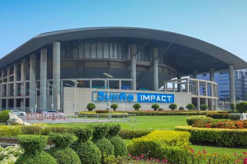 a large building with a sign in front of it at Spacious 3BR near Impact, Don Mueang Airport & Pink Line MRT in Nonthaburi