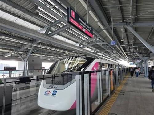 a train is parked in a train station at Spacious 3BR near Impact, Don Mueang Airport & Pink Line MRT in Nonthaburi