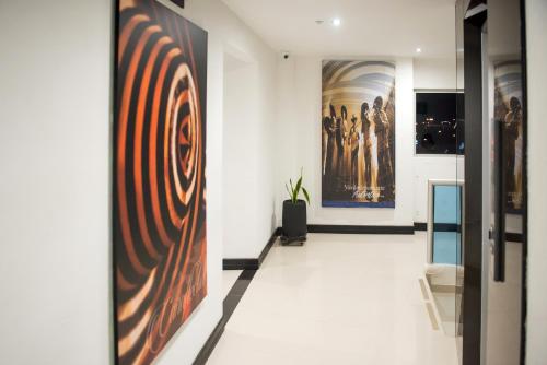 a hallway with paintings on the walls of a museum at Hotel Florida Sinú in Montería