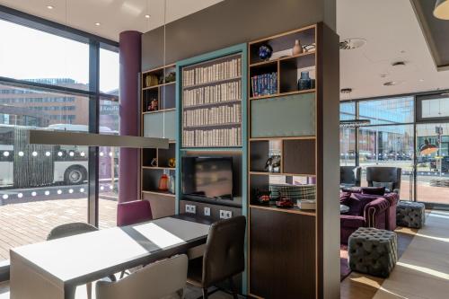 a dining room with a table and a tv at Premier Inn Hannover City Centre in Hannover