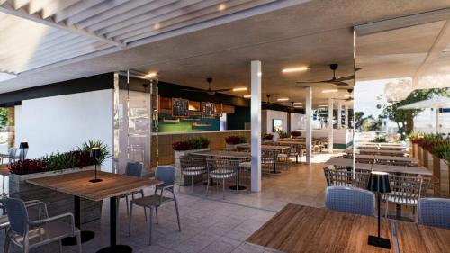 a restaurant with wooden tables and chairs and tables and chairs at Easyatent Mobile home Zelena Laguna in Poreč
