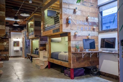 a room with a bed and a desk with a computer at PodShare East Hollywood in Los Angeles