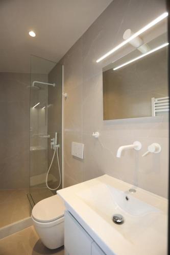 a bathroom with a sink and a toilet and a shower at VF34 Patio House in Ermoupoli