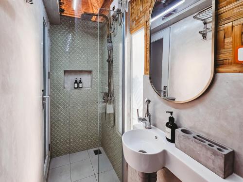 a bathroom with a sink and a shower and a mirror at Teresito Dragon Fruit Farm in Bantayan Island