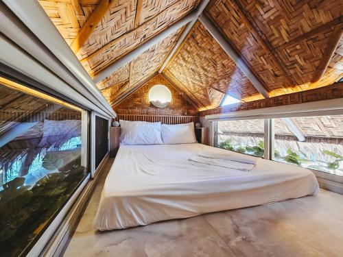 a bed in a room with a large window at Teresito Dragon Fruit Farm in Bantayan Island