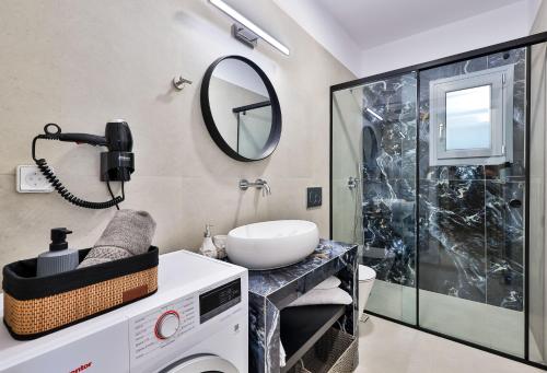 a bathroom with a sink and a shower at Etherio Apartments Naxos in Galanádhon