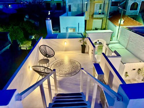 a balcony with a table and chairs on a house at Traditional Villa Sofia in Koskinou