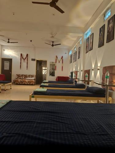 a group of beds in a room with m signs on the wall at Green male rooms in Bhopal