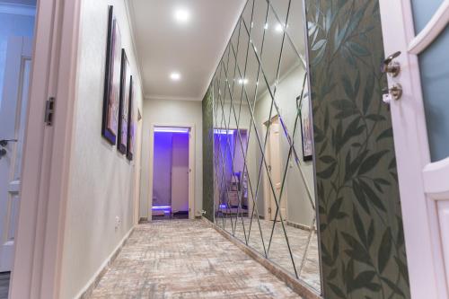 a hallway with a mirror and a purple door at Complex Rediu 54 - Penthouse Nr. 41 in Iaşi