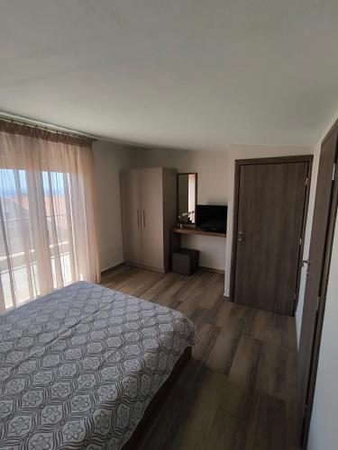 a bedroom with a bed and a door to a room at Villa Emily in Nikiti