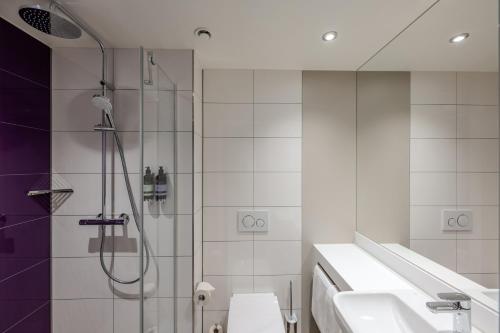 a bathroom with a shower and a toilet and a sink at Premier Inn Hannover City Centre in Hannover