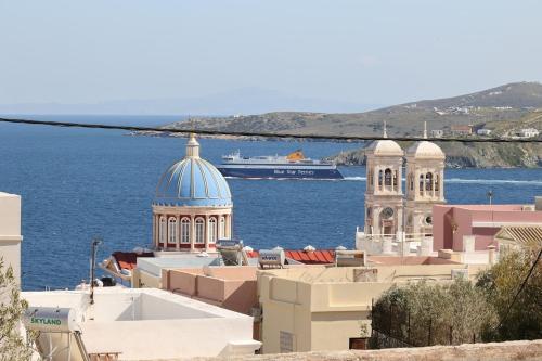 a cruise ship in the water next to buildings at VF34 Seaview House in Ermoupoli