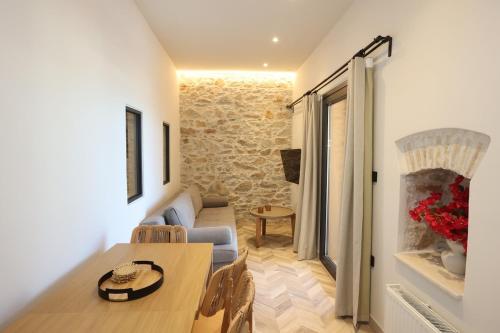 a small living room with a table and a couch at VF34 Seaview House in Ermoupoli