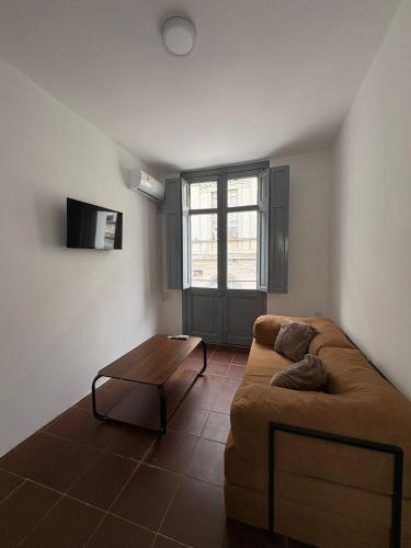 a living room with a couch and a coffee table at Apartamentos Plaza Minas in Minas