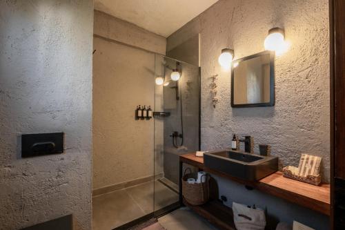 a bathroom with a sink and a shower at GAIA ALAÇATI in Alaçatı