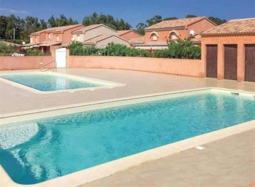 a swimming pool in front of a house at Maison à proximité de la plage in Prunete