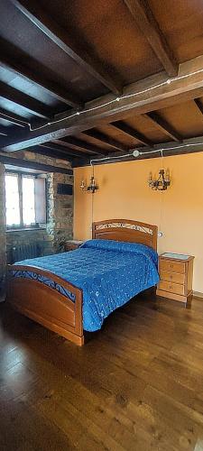a bedroom with a wooden bed in a room at Casa Rosario in Cortina