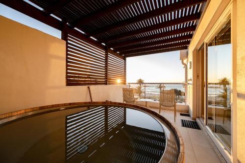 a house with a swimming pool and a balcony at The Bay Hotel in Cape Town