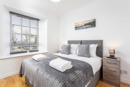 a bedroom with a bed and a window at No1 Coppergate - Donnini Apartments in Prestwick